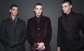 Three male models stood next to each other in suits