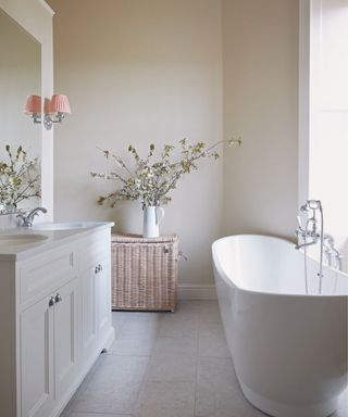 A plaster bathroom with a standing bathtub