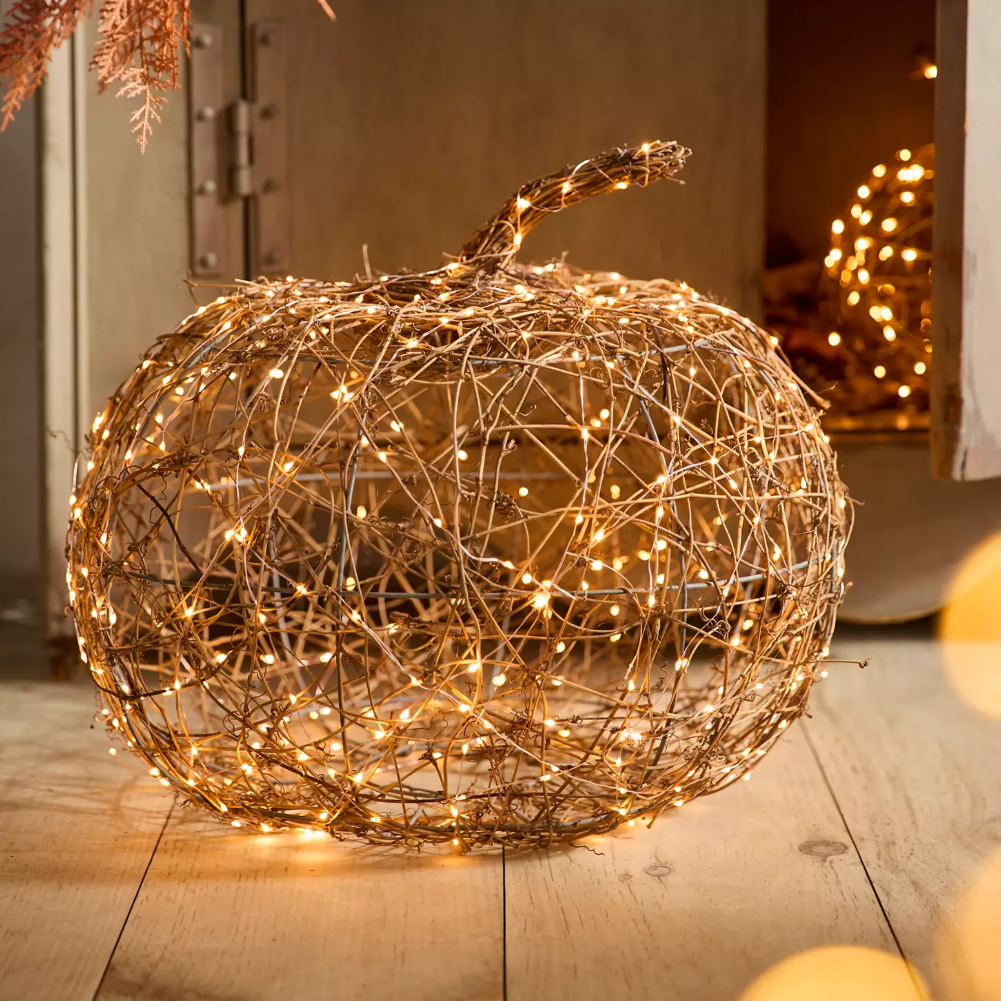 Halloween pumpkins made with woven rattan and string lights