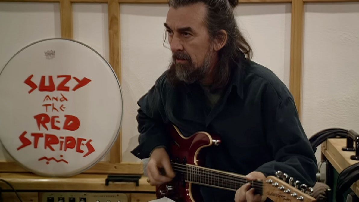 George Harrison with a Hamburguitar in a still from the Now And Then making of documentary