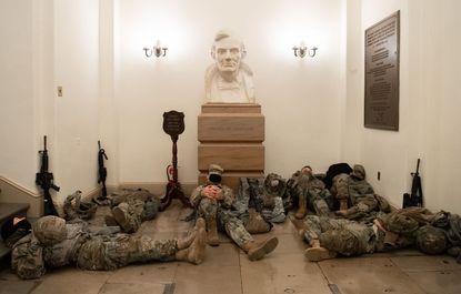 National Guard troops rest in U.S. Capitol.