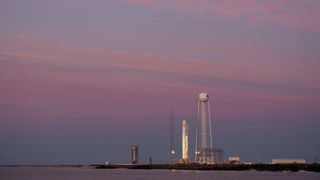 The Antares rocket that will launch the Cygnus CRS-11 cargo mission to the International Space Station stands tall on Pad-0A at NASA's Wallops Flight Facility in Virginia during sunrise on April 16, 2019, one day ahead of its planned launch.