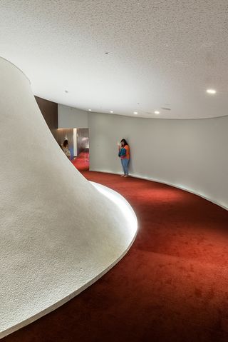 Passageways in the National Taichung Theater with white walls and red carpets