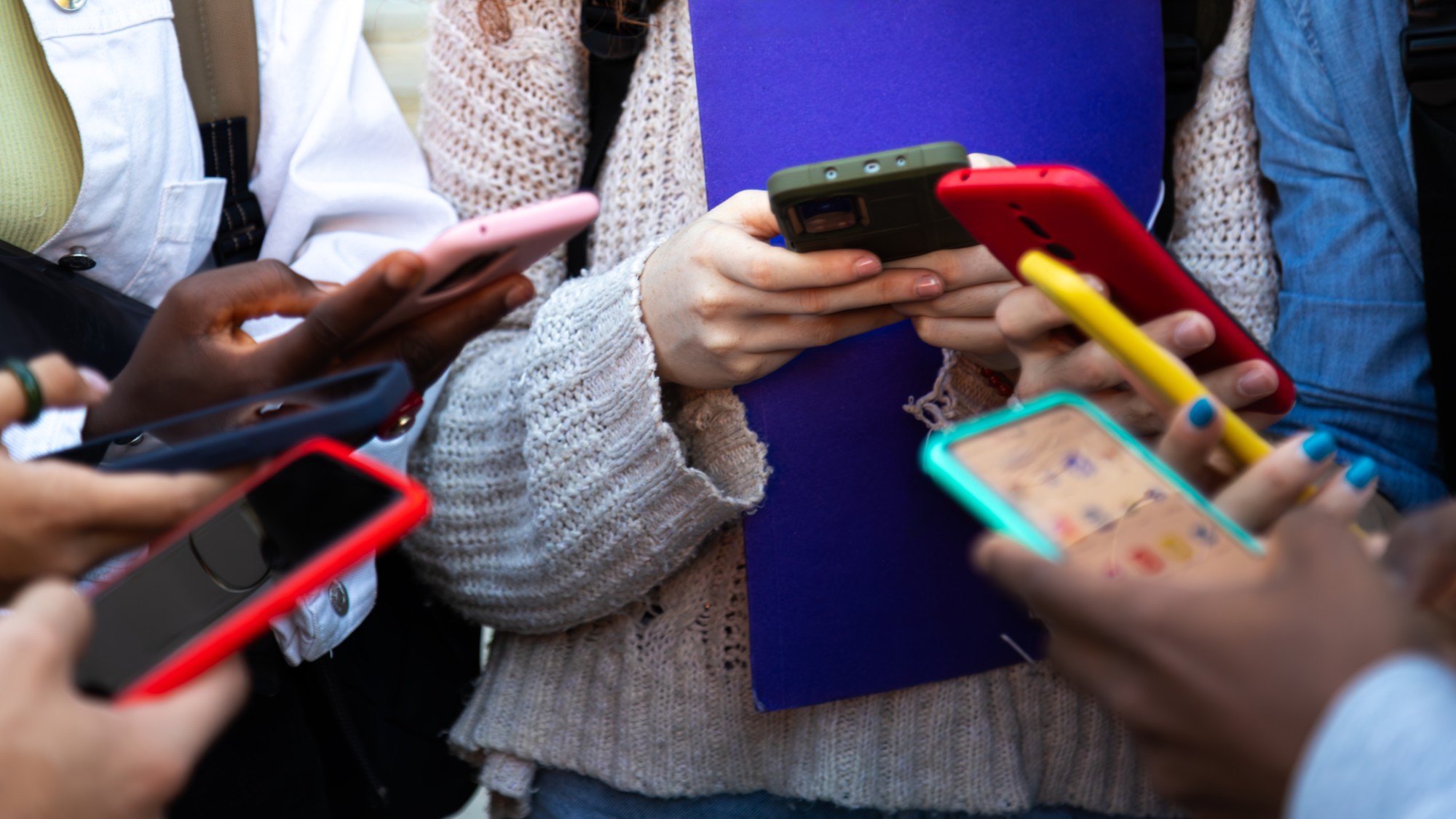 A stock photo of kids using their cell phones. 
