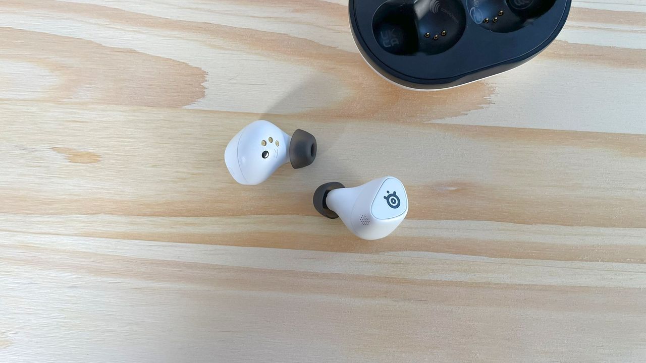 The SteelSeries Arctis GameBuds on a wood table