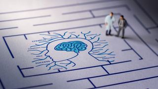 A diagram of a brain surrounded by a maze with people walking toward the brain