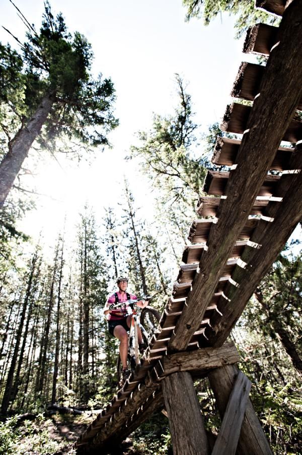 A rider is about to pass overhead on a man-made bridge