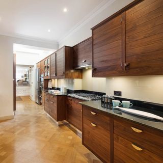 kitchen with brown cabinet and wooden flooring