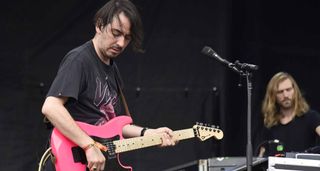 Dhani Harrison plays a hot-pink Charvel Superstrat onstage in Houston, TX.