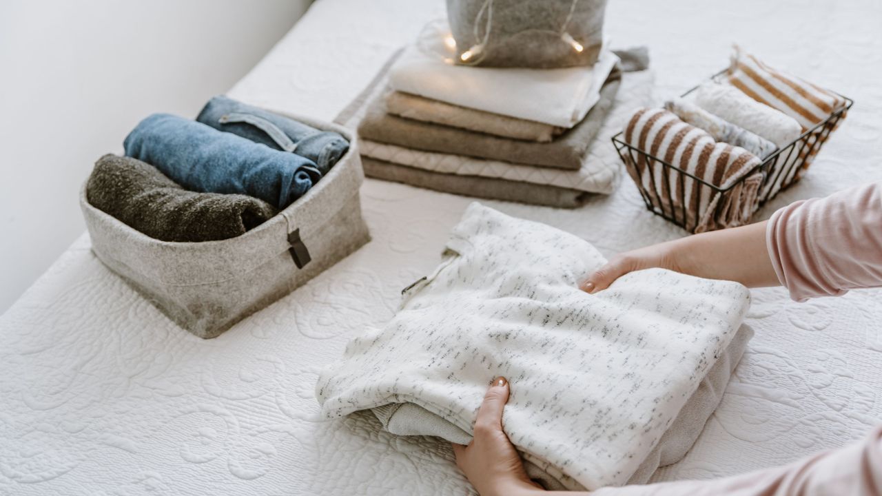 Folding clothes into baskets