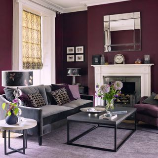 plum coloured living room with sofa, coffee table, and furnishings