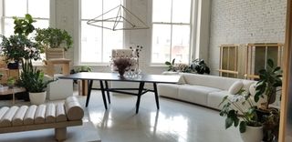 Colony design exhibition space with white sofa and black coffee table