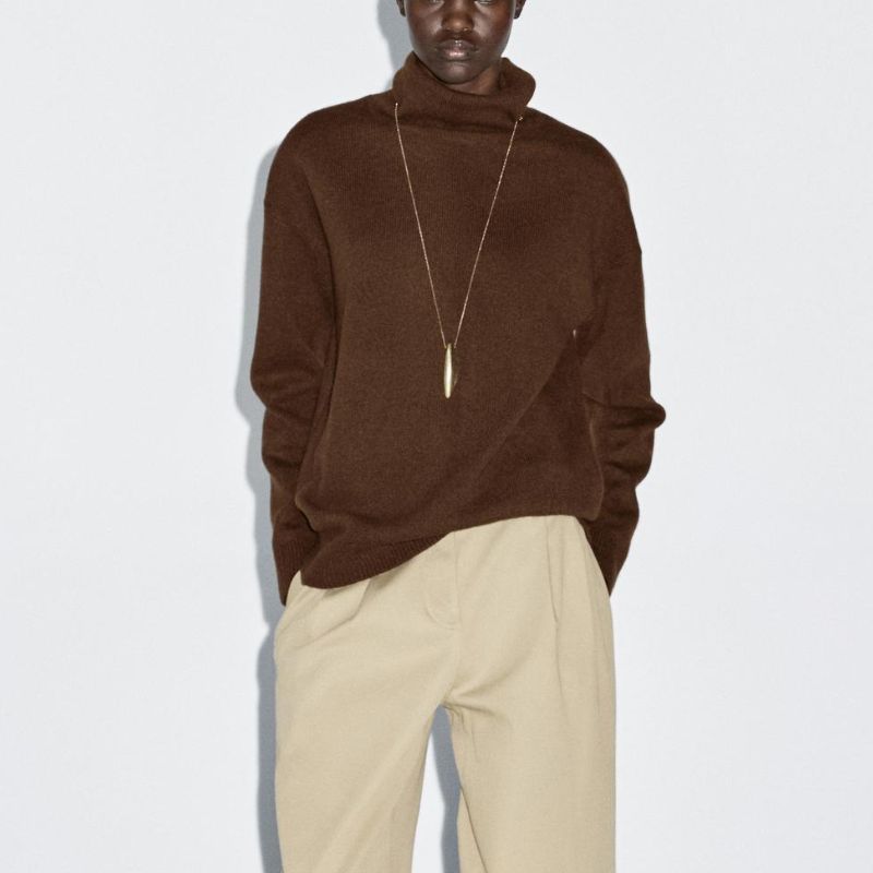 Wool blend knit turtleneck sweater on model 