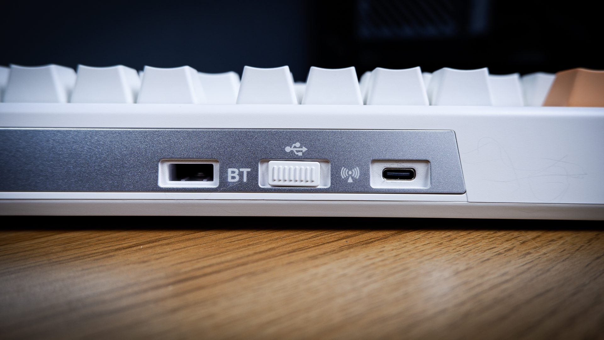 The Ducky One X induction gaming keyboard on a blue mat on a desk, with keycaps removed.