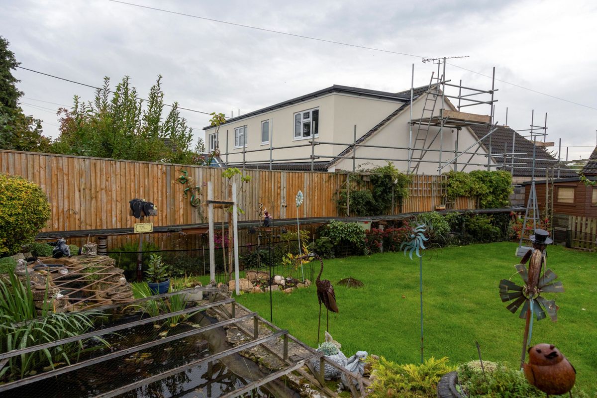 A large loft conversion for a white bungalow as can be seen from a neighbour&#039;s garden