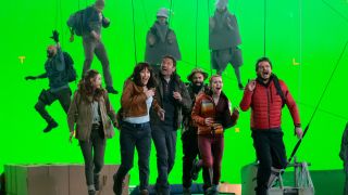 The cast of The Bubble running in front of a green screen.