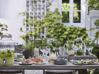 Outdoor table set up with canapes and cocktails