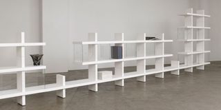 Each module of the shelving system is made from liquid plaster, with a matte white finish