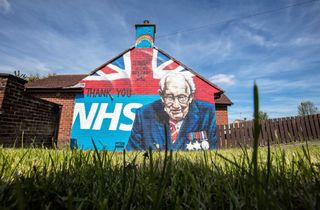 A mural of Tom Moore on the side of a house in Ireland