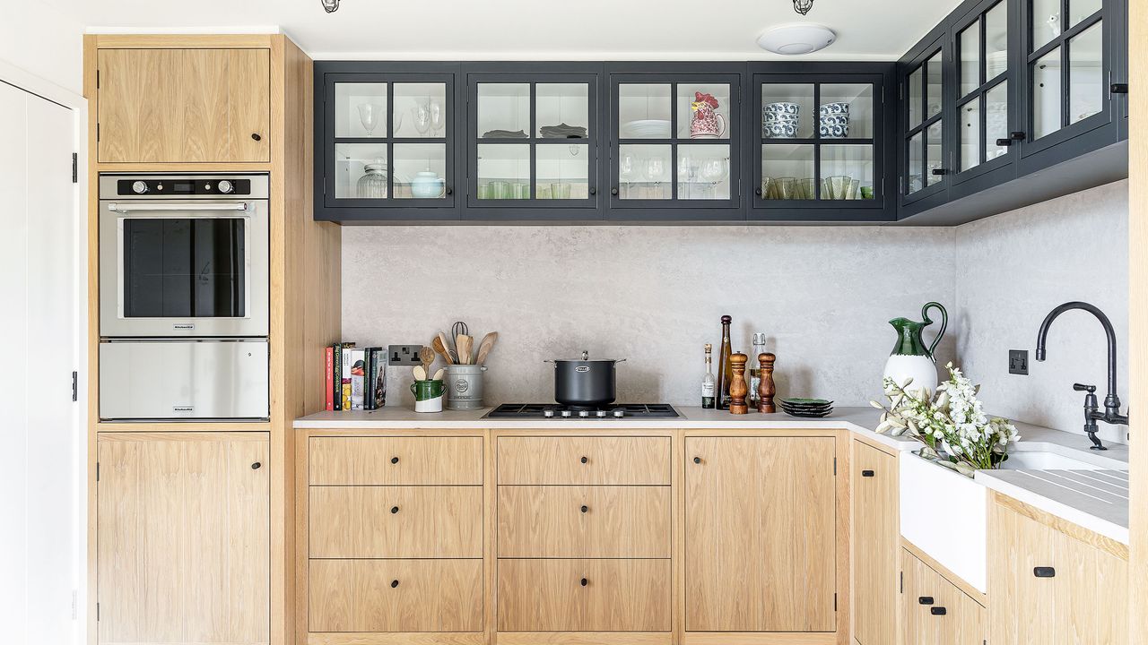 wooden cabinets in neutral kitchen with large sink and microwave