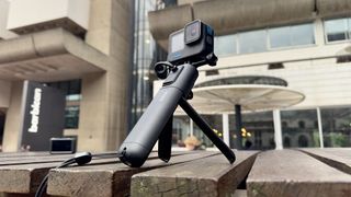 GoPro camera on a tripod outside sitting on a brick wall