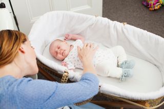 baby in Moses basket