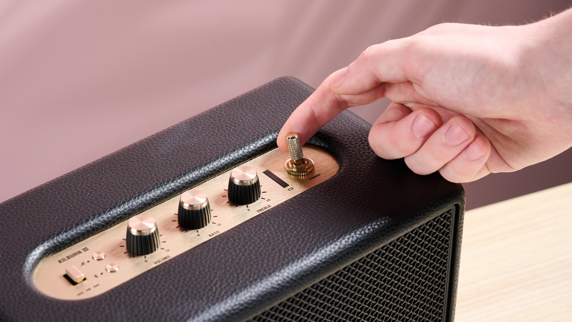 Person powering on the Marshall Kilburn III