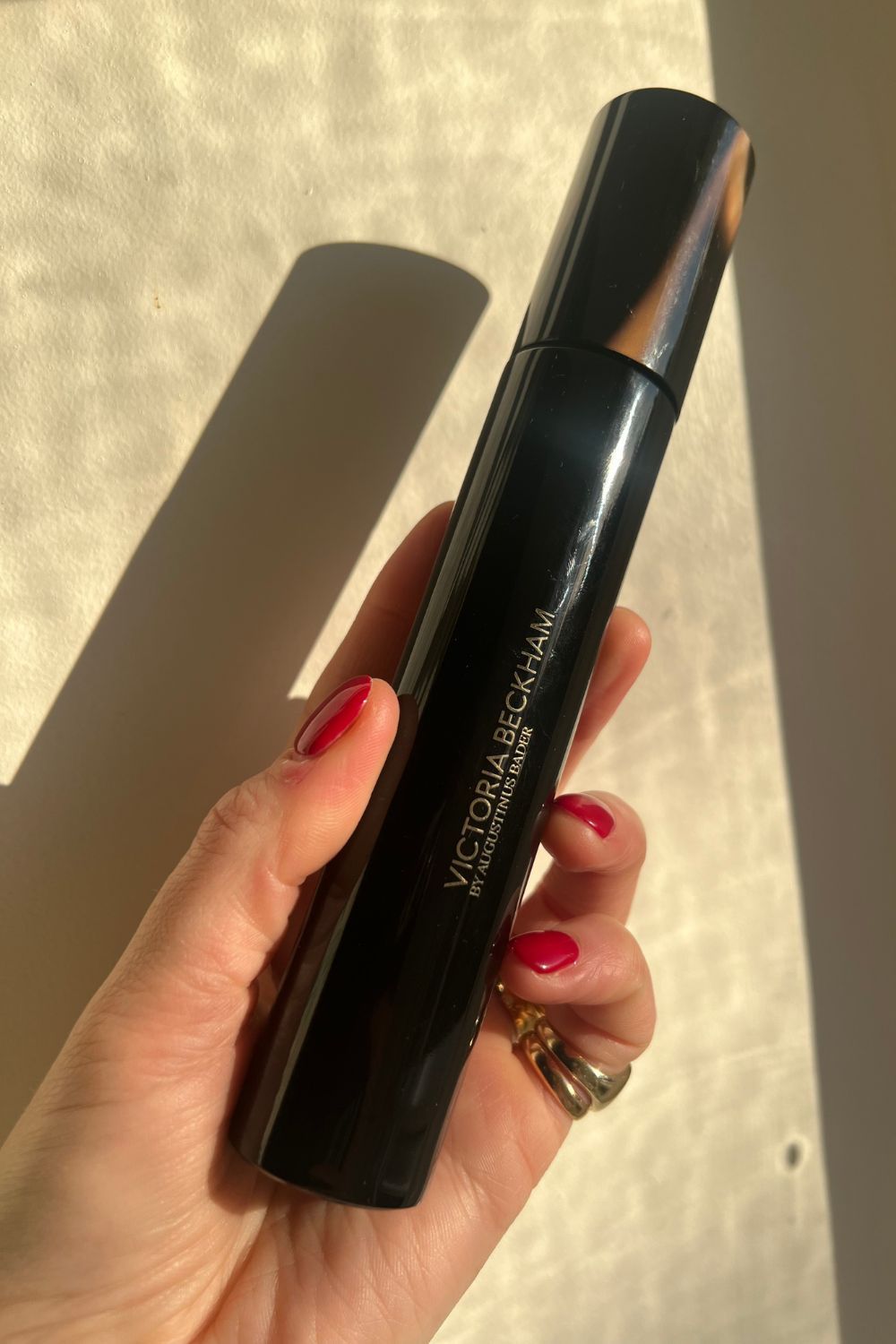 Katie Thomas holds a bottle of Victoria Beckham Cellular Rejuvenation Priming Moisturizer