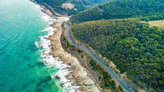 Cars driving on Great Ocean Road, Victoria, Australia - aerial view