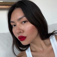 Creator @mimixn taking a selfie with a bold red lip