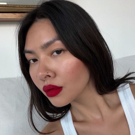 Creator @mimixn taking a selfie with a bold red lip