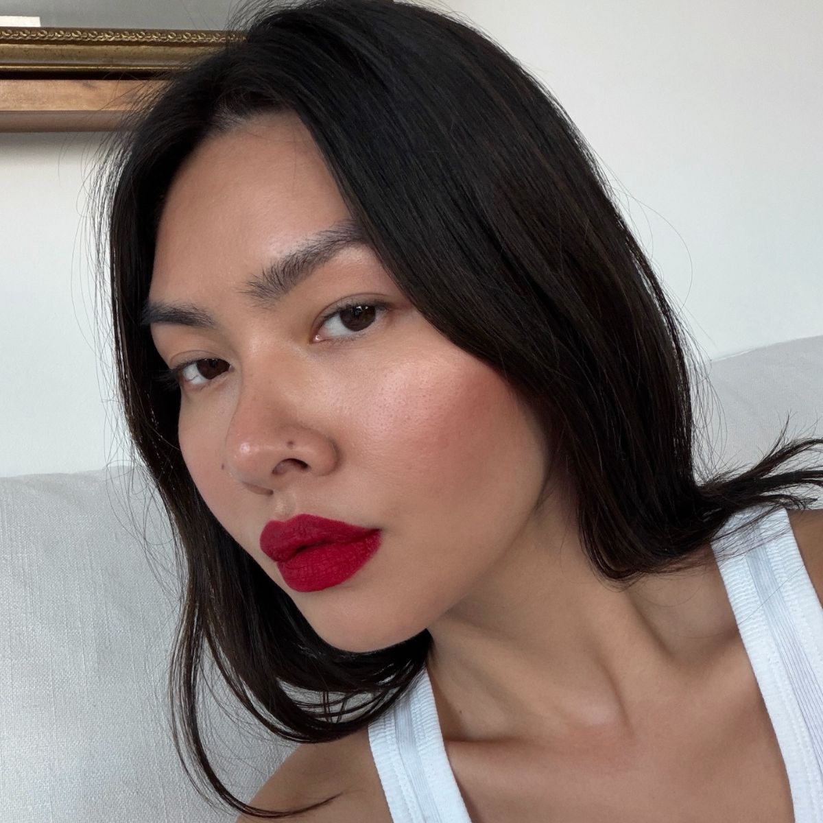 Creator @mimixn taking a selfie with a bold red lip