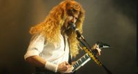 Dave Mustaine of Megadeth pictured playing a Jackson King V live in the '90s.