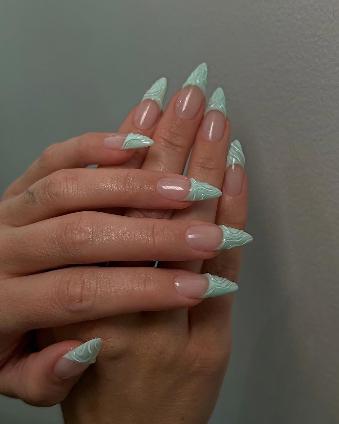 Textured sage green French tips.