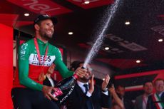 Team Ineos' Italian rider Filippo Ganna celebrates on the podium after winning the 14th stage of the 107th Giro d'Italia cycling race, a time trial between Castiglione delle Stiviere and Desenzano del Garda, on May 18, 2024. (Photo by Luca Bettini / AFP) (Photo by LUCA BETTINI/AFP via Getty Images)