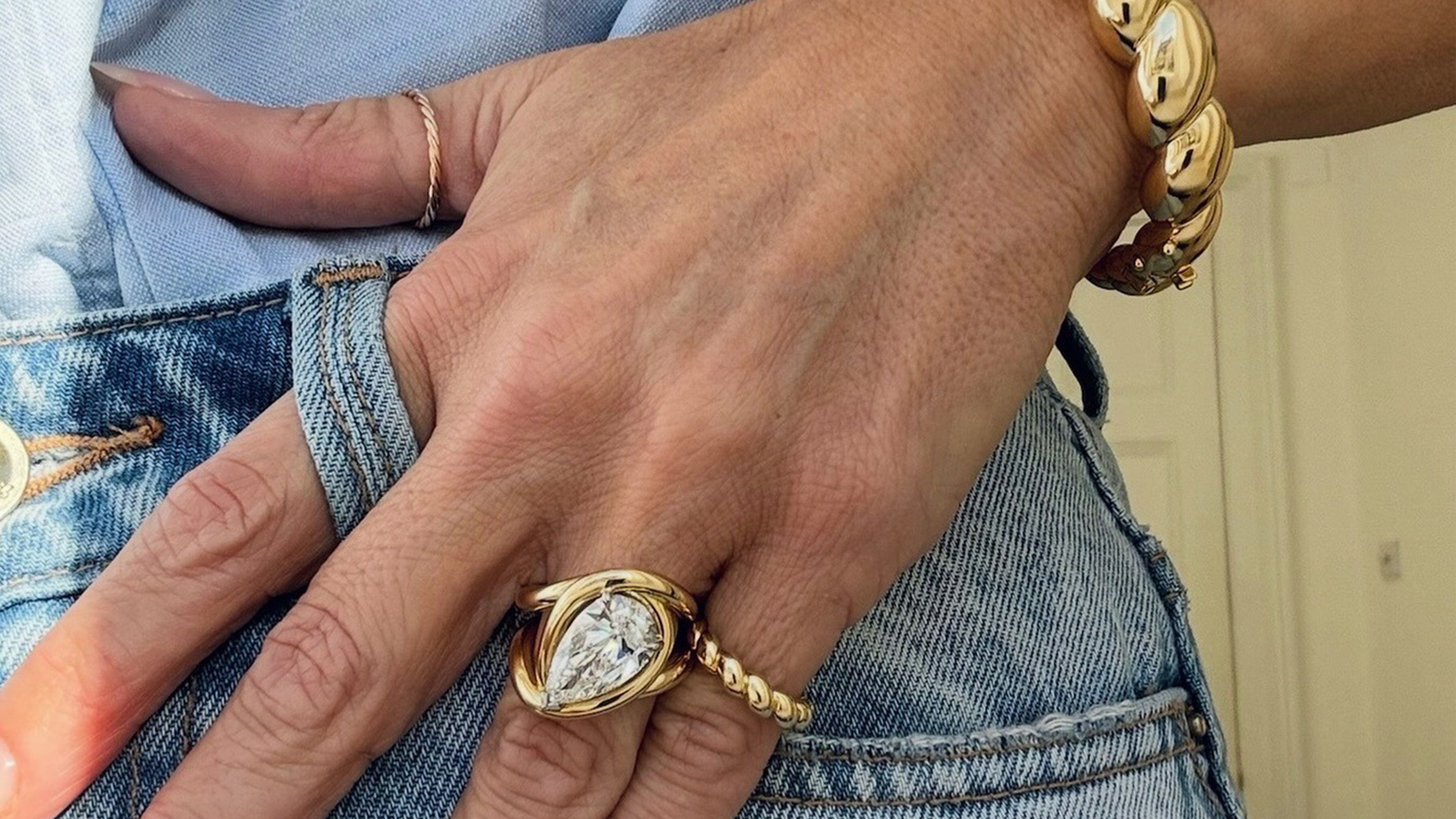A woman wearing a luxury engagement ring from Jessica Mccormack