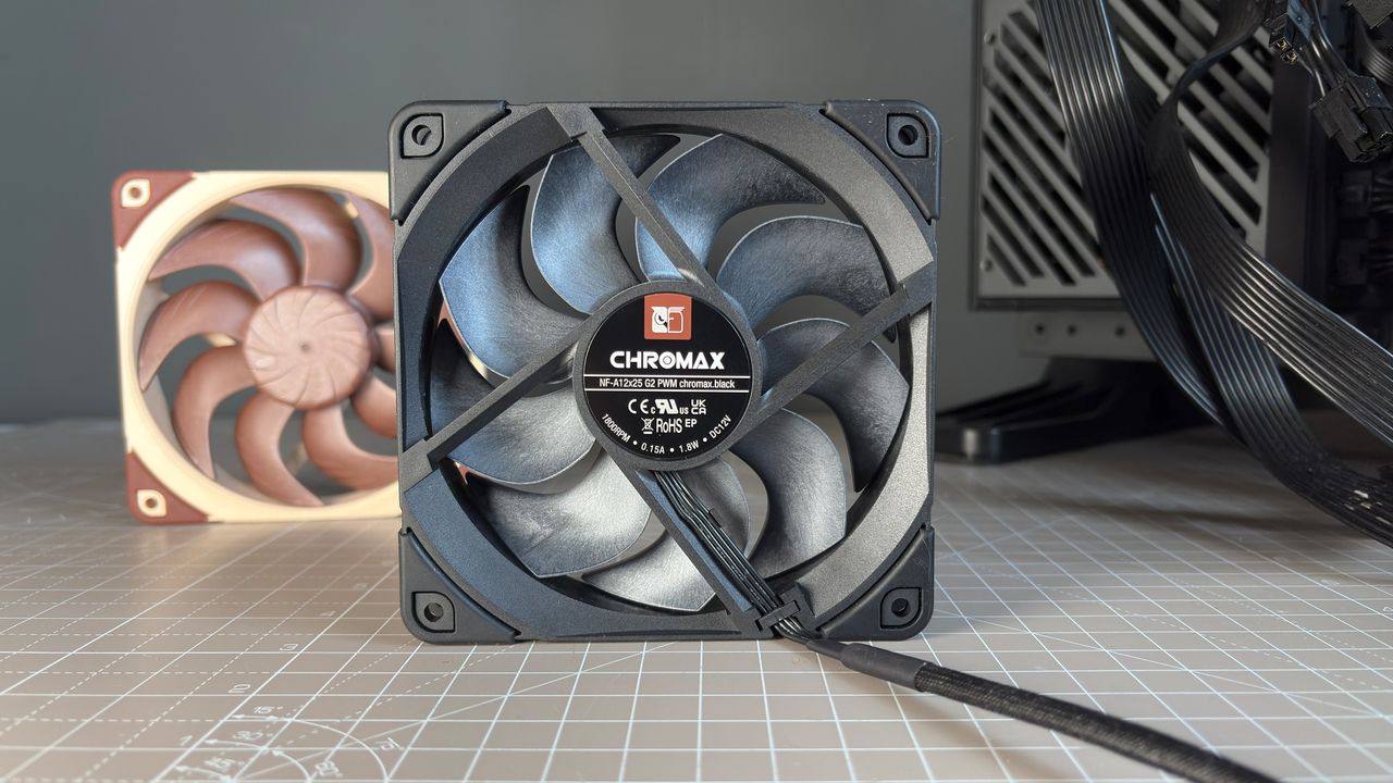 Various PC fans on a table with testing equipment for a round of batch tests.