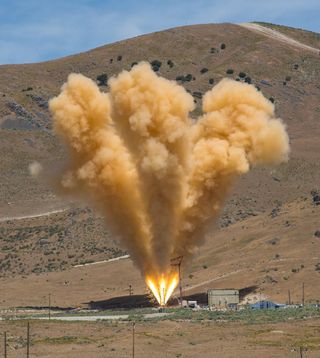 The abort motor engine for the abort flight system on NASA's Orion human space capsule, undergoing on a static fire test at the Orbital ATK facility in Corinne, Utah.