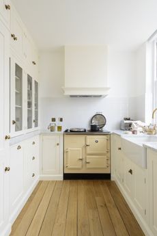 small shaker style kitchen with a cream range, Belfast sink and white color scheme