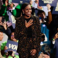 Michelle Obama holds her hand over her heart onstage at a Harris Walz Rally in Michigan on Saturday night