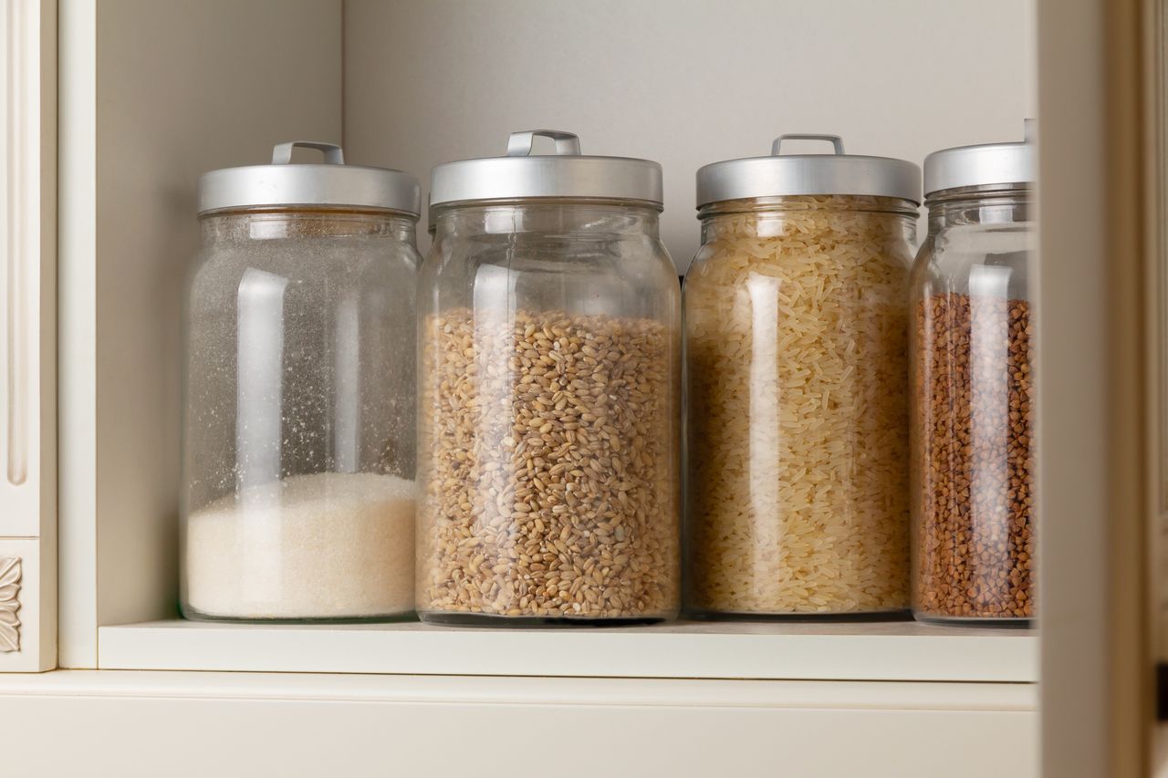 Glass jars containing dry food on a shelf