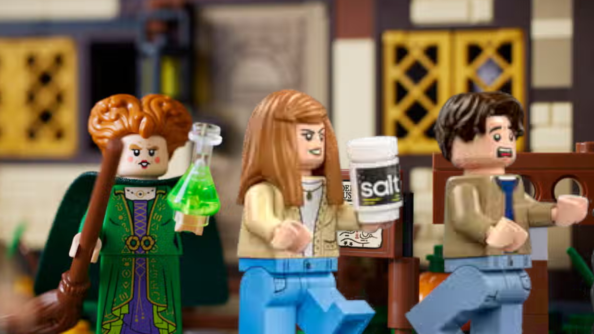 Lego Sanderson Sister chasing scared minifigures against a slightly blurred background