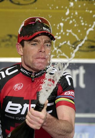 Stage winner Cadel Evans uncorks the bubbly.