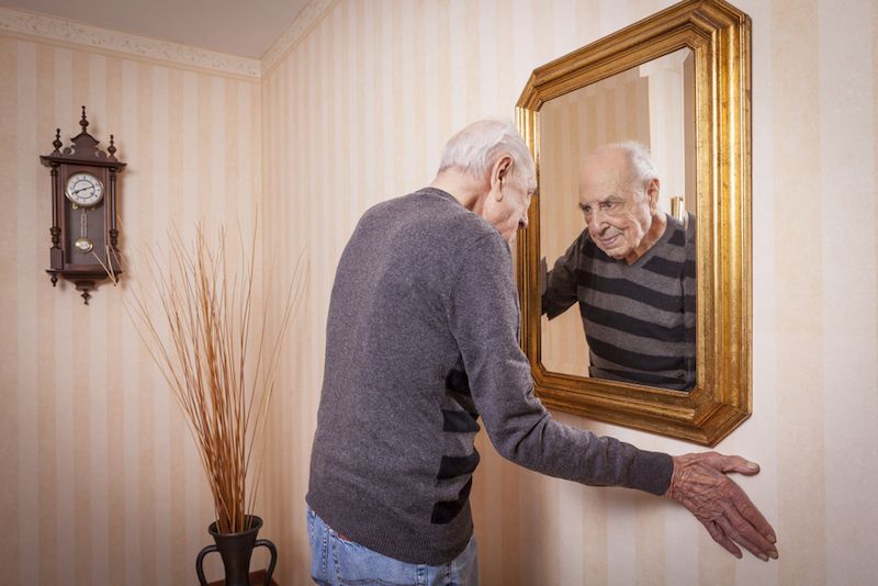 man looking at mirror