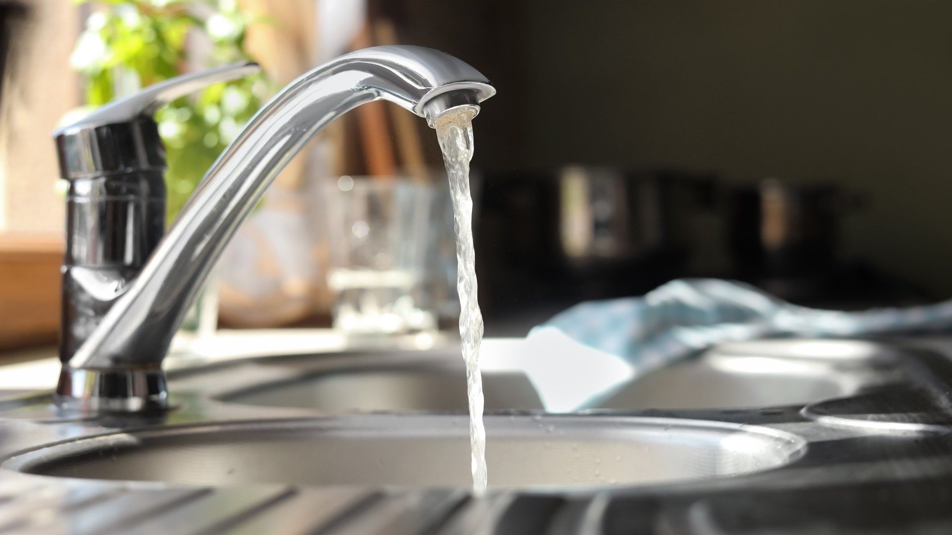a tap running over a sink in a kitchen