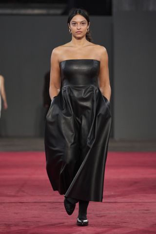 woman on Gabriela Hearst Runway in black leather dress