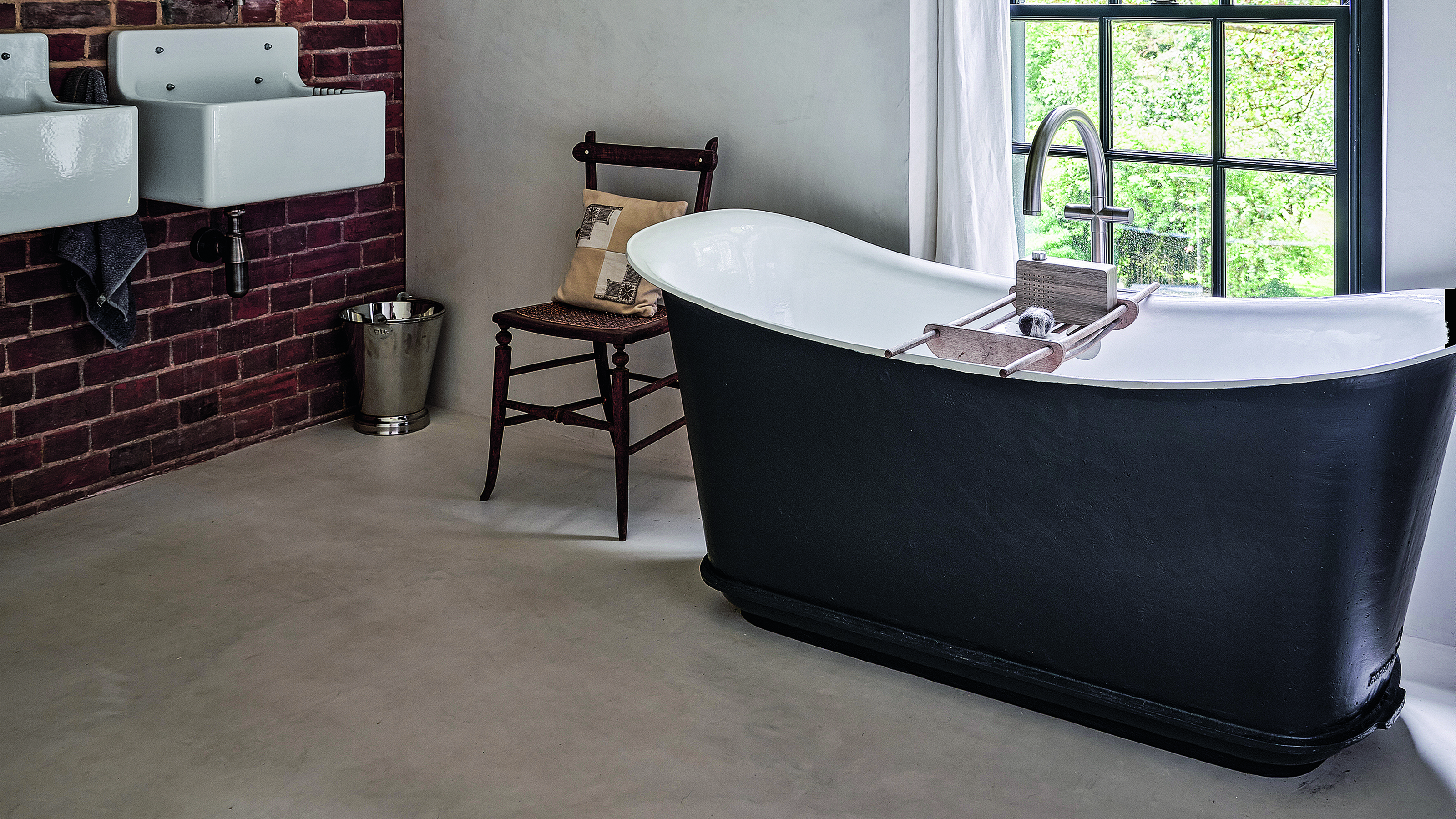 Bathroom with freestanding bath and wooden chair