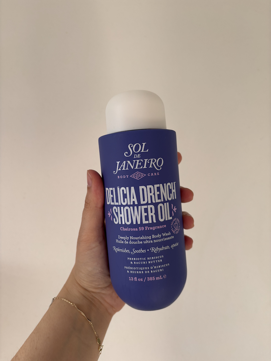 Mica Ricketts holding Sol de Janeiro Delícia Drench Shower Oil