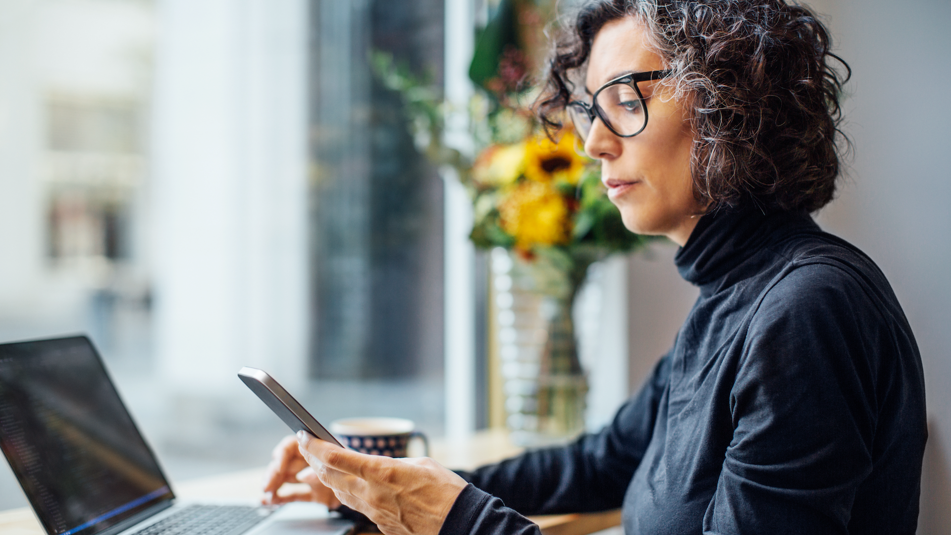 Woman using phone at desk