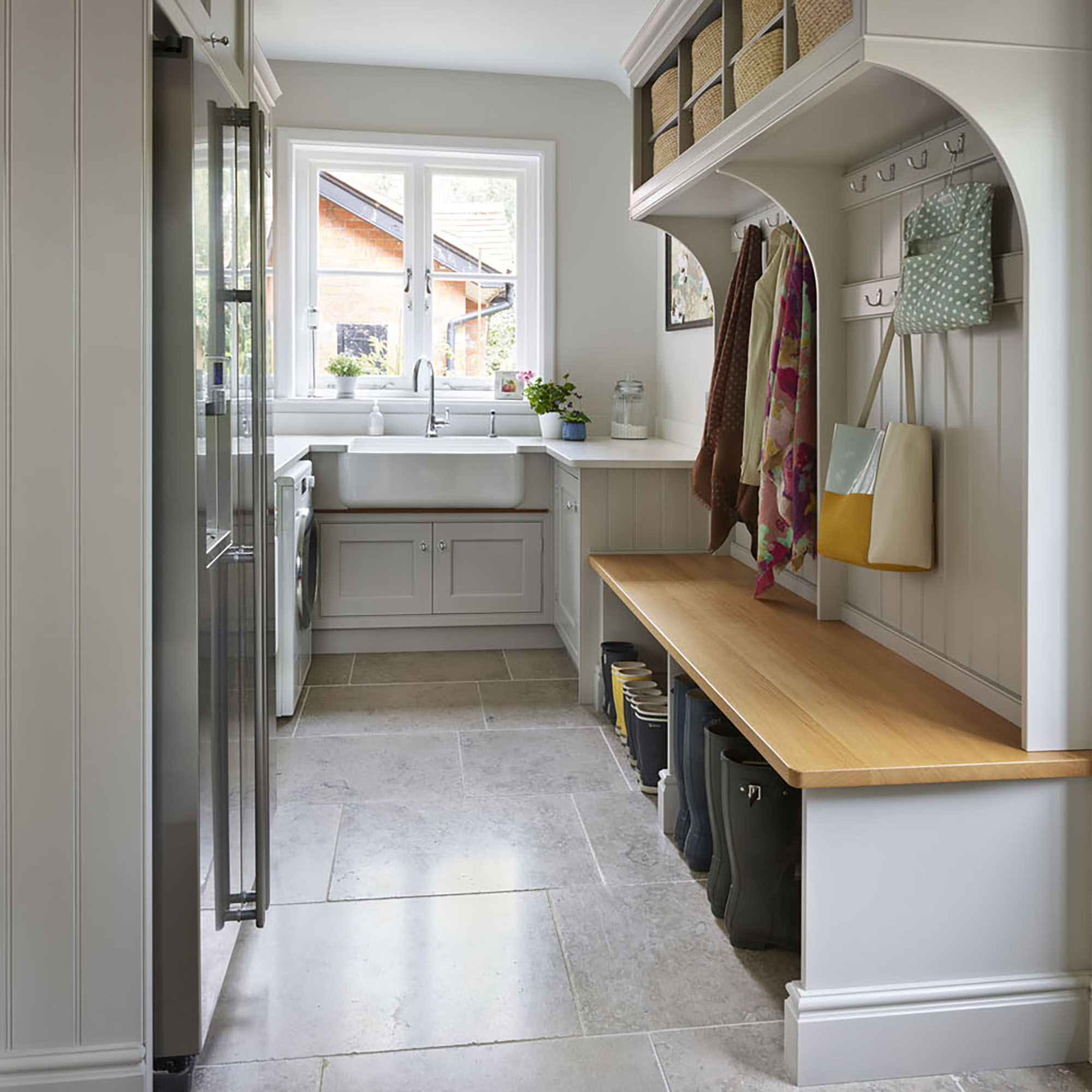 Utility room with light sage shaker units and built in boot room